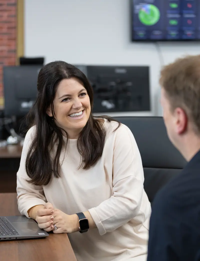 CAP Technologies team members chatting with a client