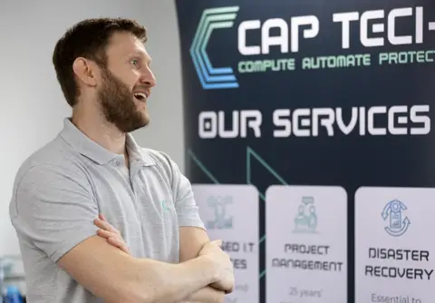 CAP team member by the services banner